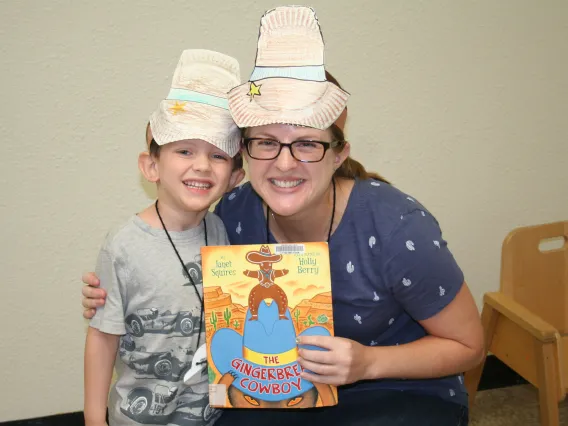 PhD student with camper holding book