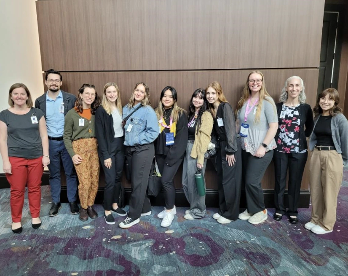 Two Audiology faculty and 9 grad students in group photo 