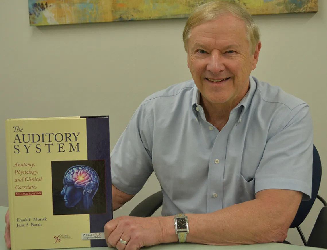 Dr. Frank Musiek with his new textbook